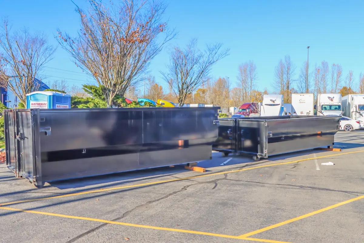 Professional dumpster rental service with roll-off container on residential driveway in Brockton
